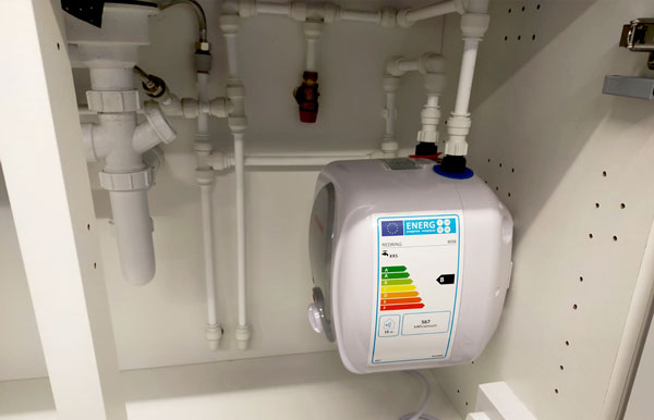 New plumbing work inside a kitchen unit
